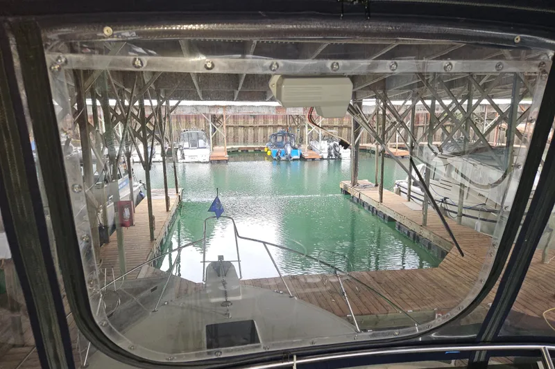 Slide: The Image of 1989 Tollycraft Sport Sedan helm with steering wheel, gauges, and navigation equipment. - 6