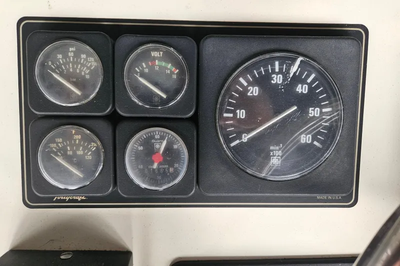 Slide: The Image of 1989 Tollycraft Sport Sedan helm view in marina with docked boats. - 7