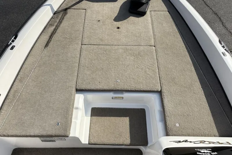 Slide: The Image of 2024 ProCraft 185 Pro boat deck with beige carpeting and storage compartments. - 11
