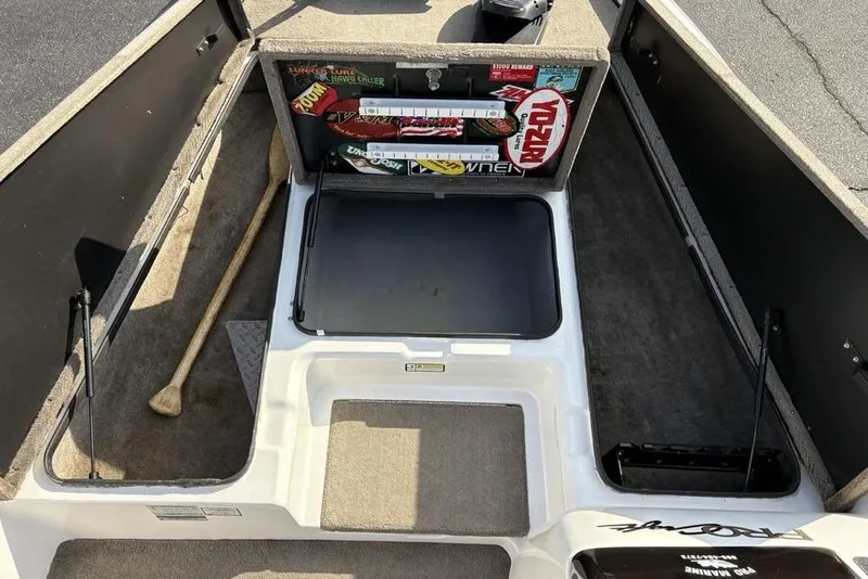 Slide: The Image of 2024 ProCraft 185 Pro boat interior with storage compartments and fishing gear. - 12