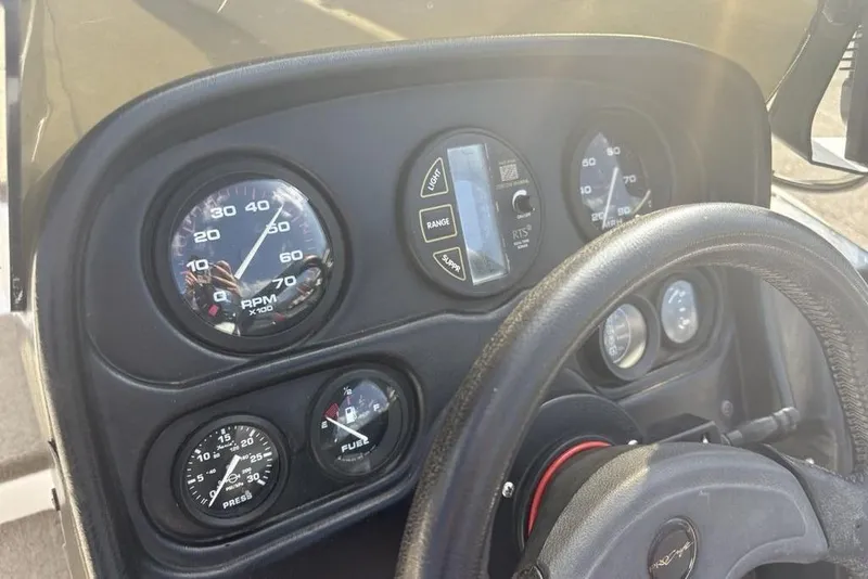 Slide: The Image of Dashboard of 2024 ProCraft 185 Pro boat with gauges and steering wheel. - 17