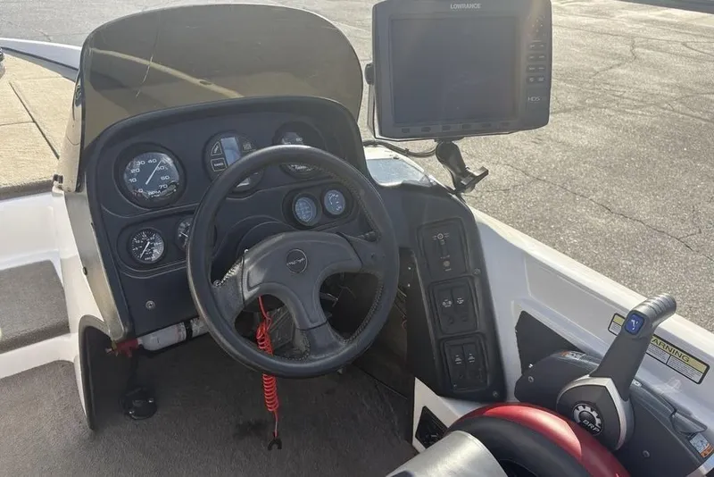 Slide: The Image of 2024 ProCraft 185 Pro boat dashboard with steering wheel and navigation system. - 18