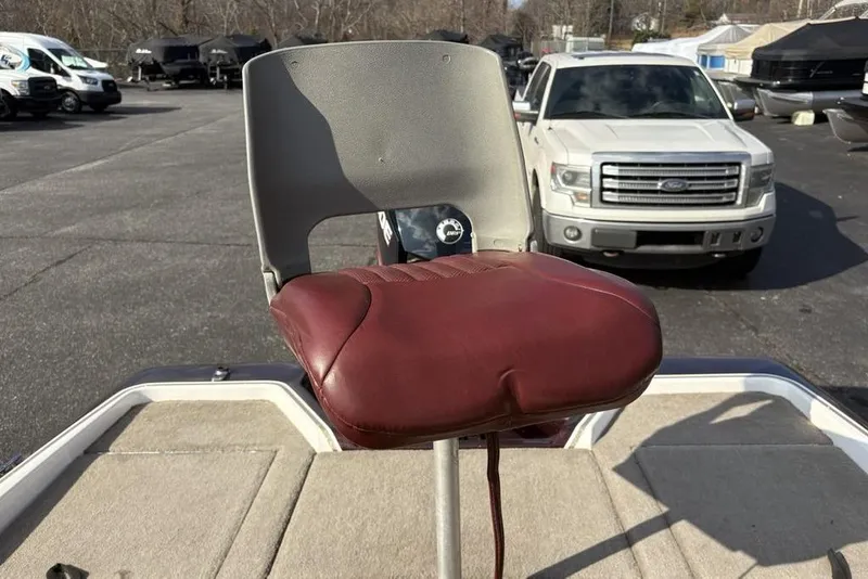 Slide: The Image of 2024 ProCraft 185 Pro boat seat with maroon cushion in a parking lot. - 23