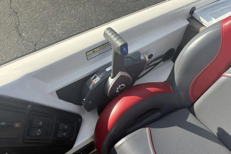 Slide: The Image of 2024 ProCraft 185 Pro boat throttle control and seat detail. - 26