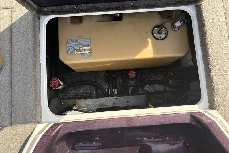 Slide: The Image of Open compartment of 2024 ProCraft 185 Pro boat showing fuel tank and wiring. - 28