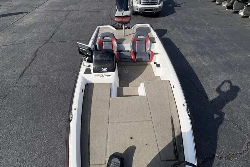 Slide: The Image of 2024 ProCraft 185 Pro boat with dual seats and spacious deck, parked on asphalt. - 31