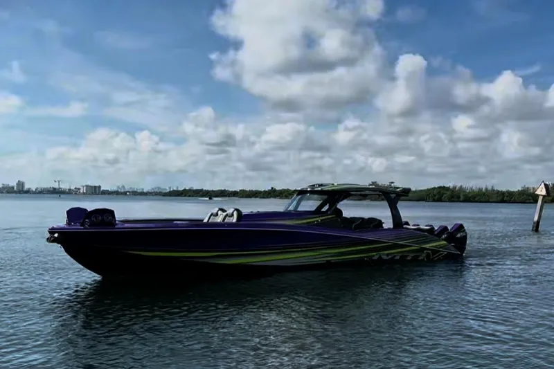 The Image of 2023 MTI 50v boat on calm water under a partly cloudy sky. - 0