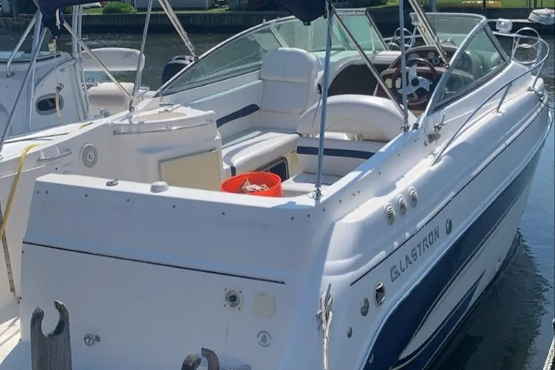 Slide: The Image of 2007 Glastron GS 279 boat docked, featuring spacious seating and sleek design. - 1