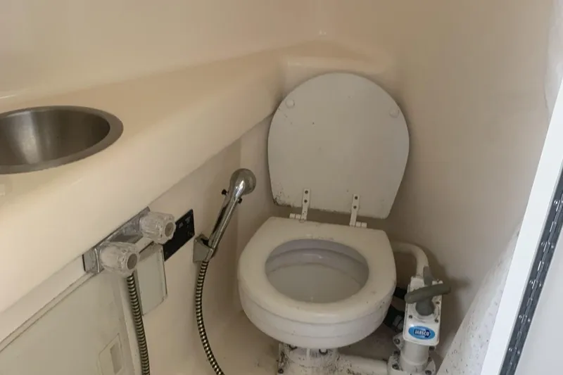 Slide: The Image of 2007 Glastron GS 279 boat bathroom with toilet, sink, and showerhead. - 5