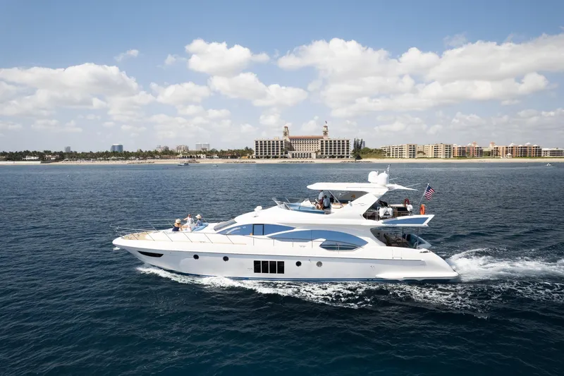 The Image of Luxury 2011 Azimut 70 yacht cruising near a coastal city under a partly cloudy sky. - 1