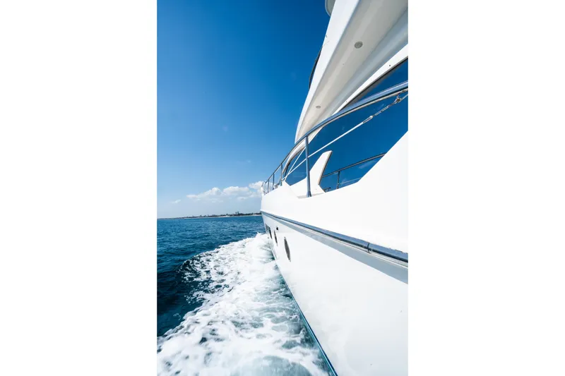 Slide: The Image of Azimut 70 yacht cruising on open sea under clear blue sky, 2011 model. - 10