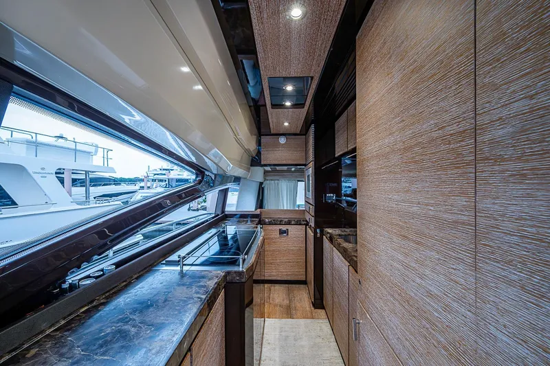 Slide: The Image of Luxurious interior of a 2011 Azimut 70 yacht with sleek wood finishes and modern amenities. - 25