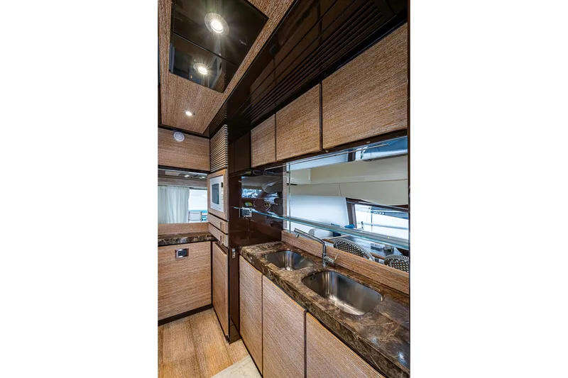 Slide: The Image of Luxurious kitchen interior of 2011 Azimut 70 yacht with modern amenities and sleek design. - 26