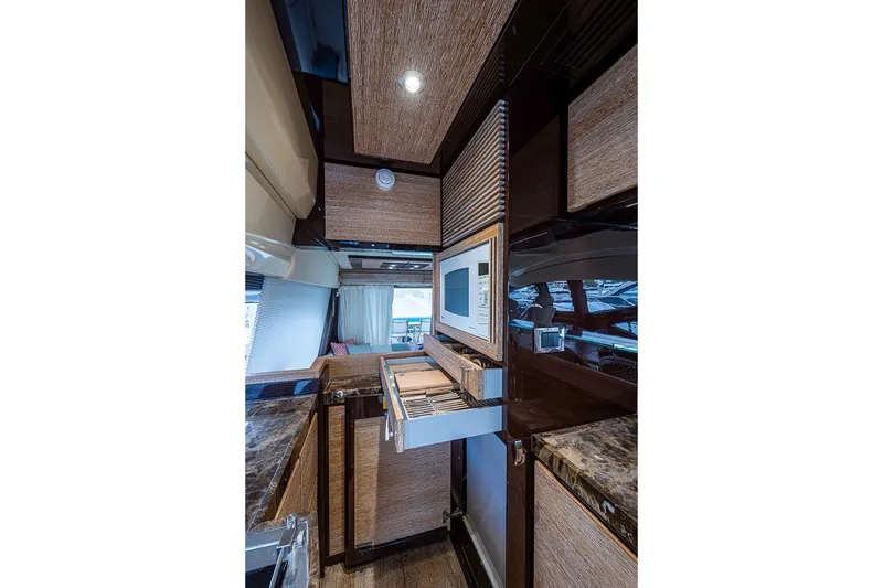 Slide: The Image of Luxurious kitchen interior of 2011 Azimut 70 yacht with modern appliances and wood finishes. - 28