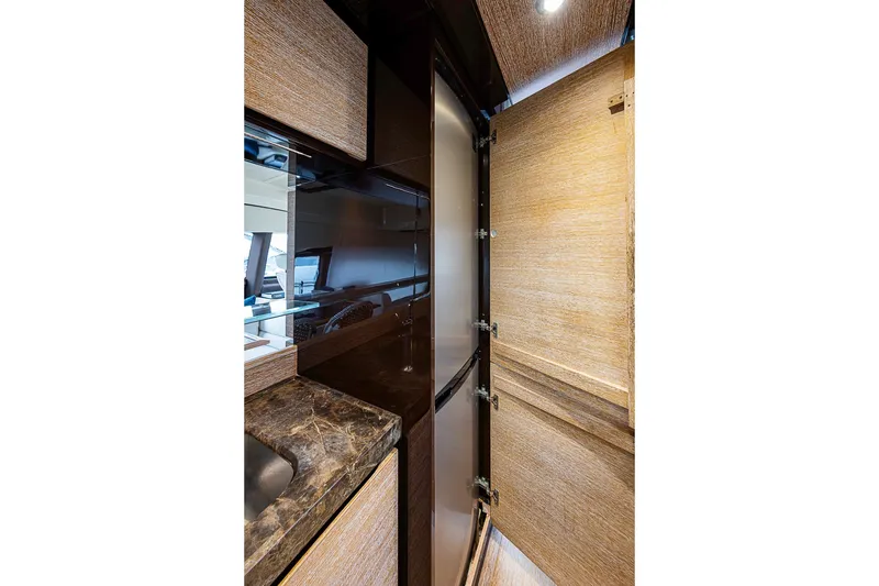 Slide: The Image of Luxurious interior of 2011 Azimut 70 yacht, featuring elegant wood finishes and modern design. - 31