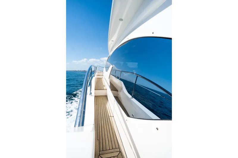 Slide: The Image of Side view of 2011 Azimut 70 yacht with wooden deck and ocean backdrop. - 9
