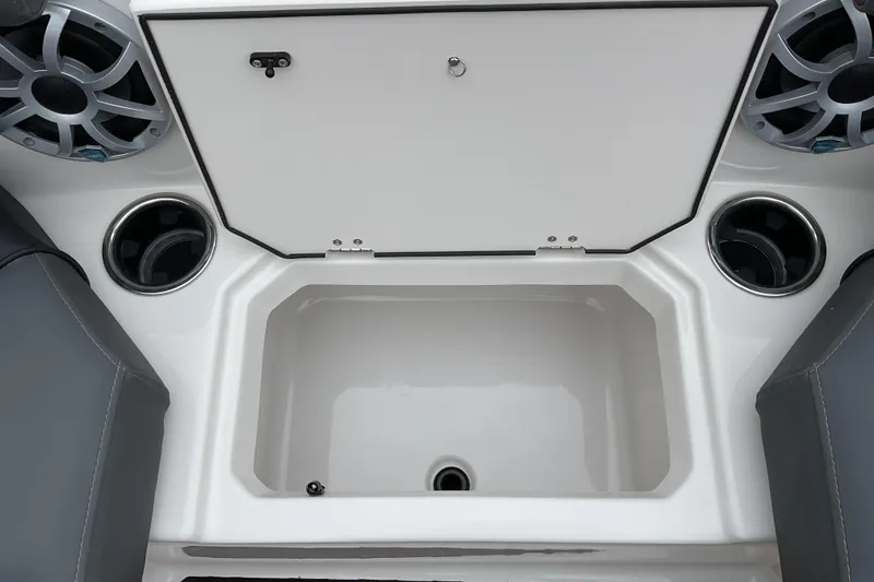 Slide: The Image of 2026 Starcraft SVX 190 OB boat interior with storage compartment and cup holders. - 16