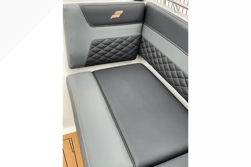 Slide: The Image of 2026 Starcraft SVX 190 OB boat interior with black and gray quilted seating. - 19
