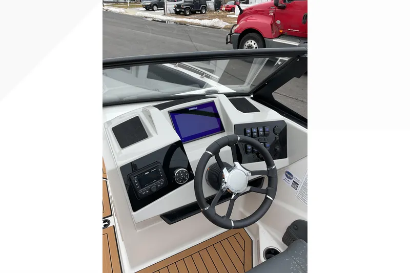 Slide: The Image of 2026 Starcraft SVX 190 OB boat dashboard with steering wheel and digital display. - 6
