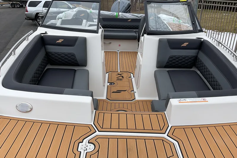 Slide: The Image of 2026 Starcraft SVX 190 OB boat interior with sleek seating and wood-style flooring. - 8