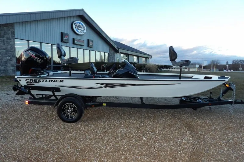 The Image of 2026 Crestliner XF 189 boat on trailer, parked outside dealership. - 1