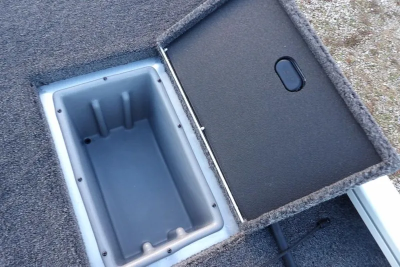 Slide: The Image of Open storage compartment in 2026 Crestliner XF 189 boat, featuring carpeted interior. - 27