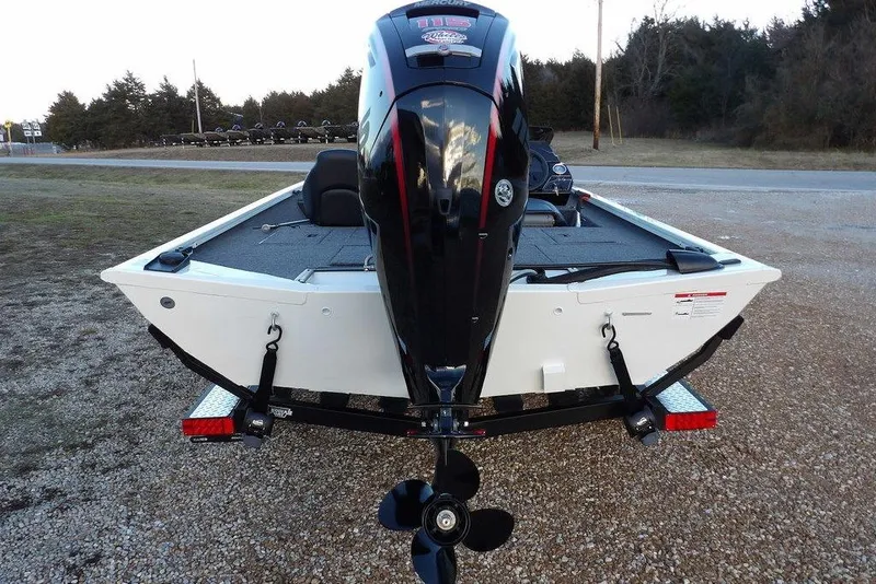 Slide: The Image of 2026 Crestliner XF 189 boat with powerful outboard motor, parked on gravel. - 3
