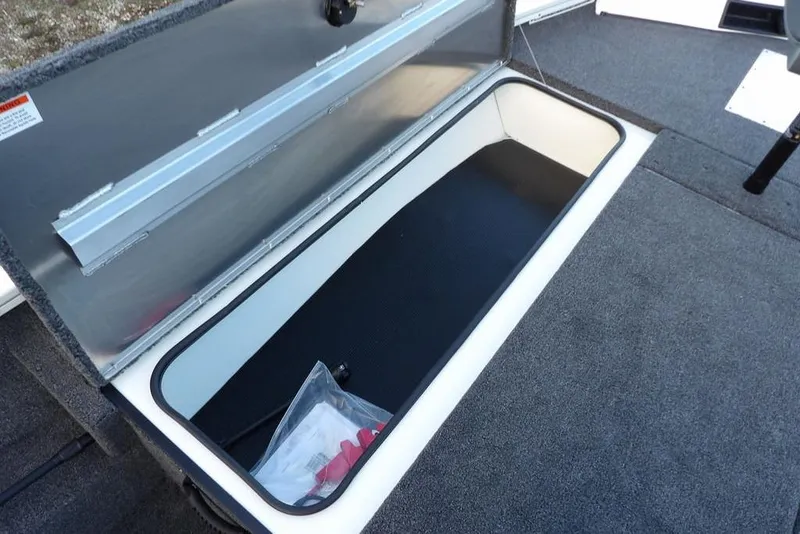 Slide: The Image of 2026 Crestliner XF 189 boat storage compartment with open lid, showcasing interior space. - 32