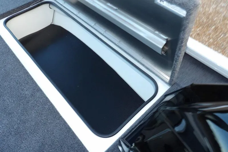 Slide: The Image of Open storage compartment in 2026 Crestliner XF 189 boat, featuring carpeted interior. - 34