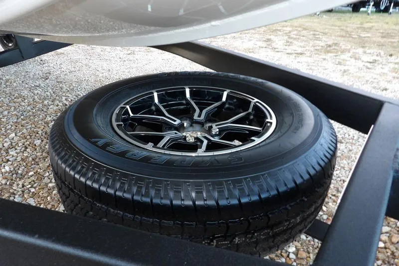 Slide: The Image of 2026 Crestliner XF 189 trailer tire on gravel surface. - 39