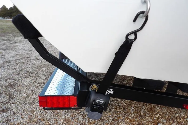 Slide: The Image of 2026 Crestliner XF 189 boat trailer with secure tie-down strap and red reflector. - 44