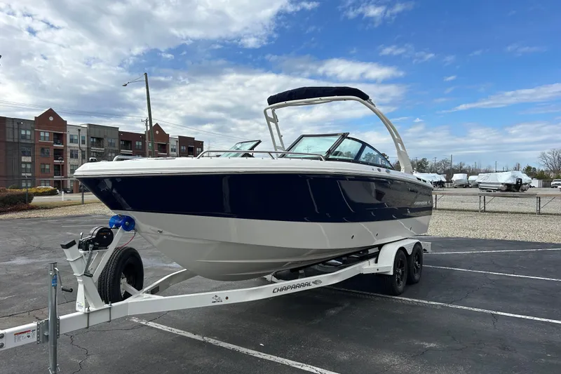 Slide: The Image of 2026 Chaparral SSX 4 boat on trailer, parked outdoors under a partly cloudy sky. - 3