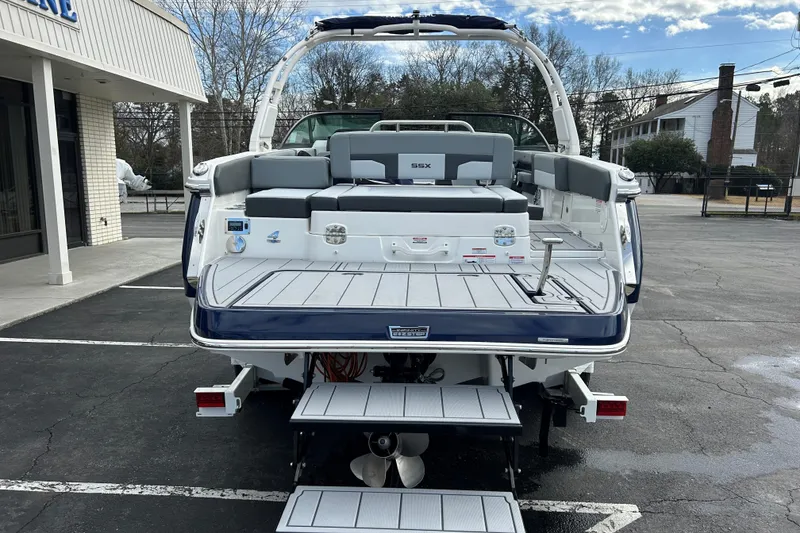 Slide: The Image of 2026 Chaparral SSX 4 boat, rear view, parked outdoors, showcasing seating and swim platform. - 5