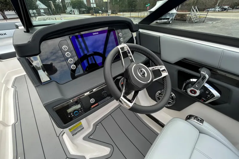 Slide: The Image of 2026 Chaparral SSX 4 boat dashboard with modern steering and digital controls. - 9