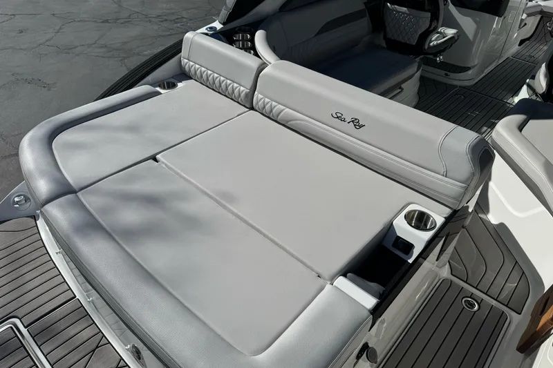 Slide: The Image of 2026 Sea Ray SLX 260 boat with luxurious gray seating and cup holders. - 11