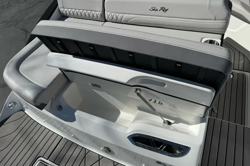 Slide: The Image of 2026 Sea Ray SLX 260 boat seating with storage compartment open. - 13