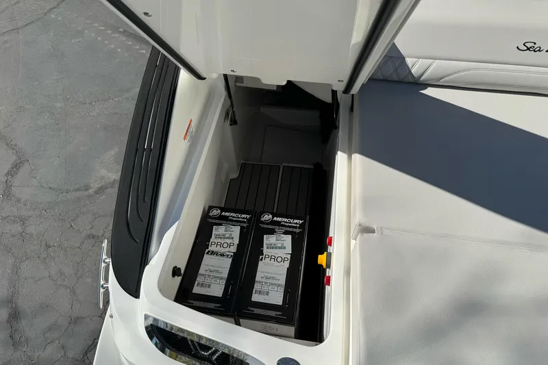 Slide: The Image of Storage compartment of 2026 Sea Ray SLX 260 boat with Mercury propeller boxes. - 14