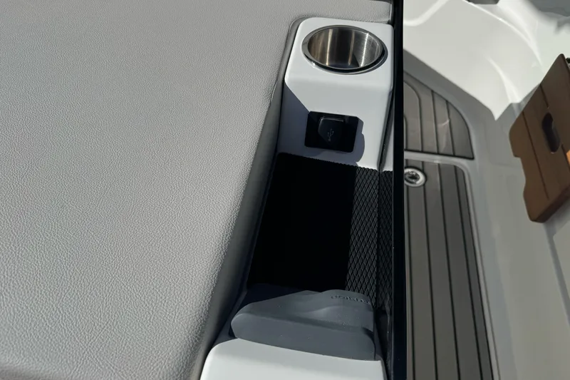 Slide: The Image of 2026 Sea Ray SLX 260 boat interior with cup holder and USB port. - 15