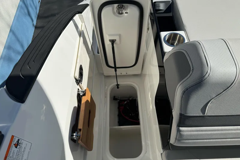 Slide: The Image of 2026 Sea Ray SLX 260 boat interior with storage compartment and seating. - 18