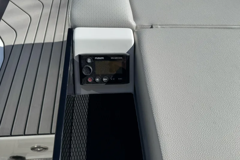 Slide: The Image of 2026 Sea Ray SLX 260 boat interior with Fusion MS-NRX300 audio control panel. - 19