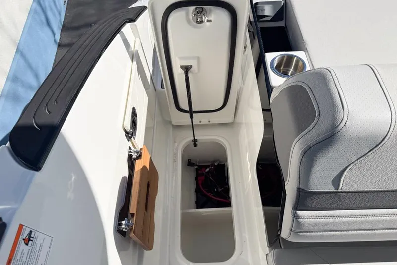 Slide: The Image of Interior view of 2026 Sea Ray SLX 260 boat, featuring storage compartment and seating area. - 14