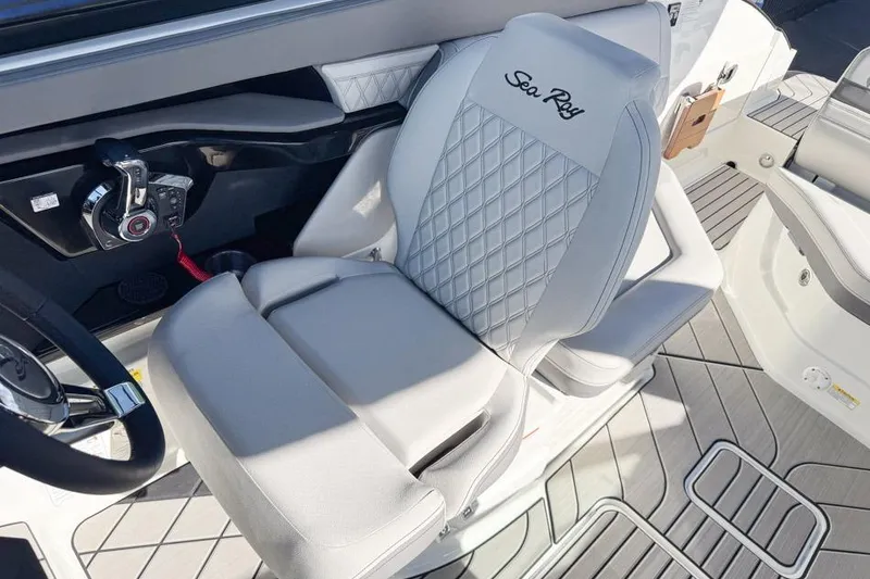 Slide: The Image of Captain's seat of 2026 Sea Ray SLX 260 boat with elegant design and controls. - 21