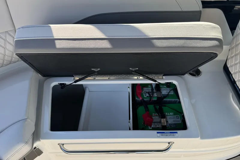 Slide: The Image of Storage compartment with batteries in 2026 Sea Ray SLX 260 boat. - 24
