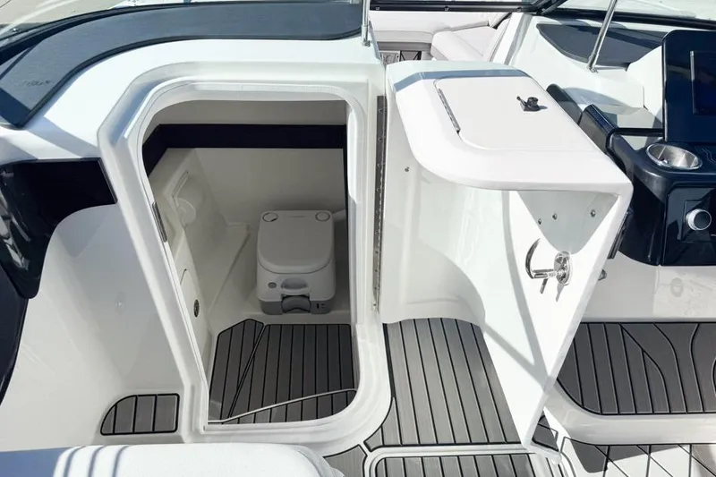 Slide: The Image of 2026 Sea Ray SLX 260 boat interior with compact marine toilet and sleek design. - 27