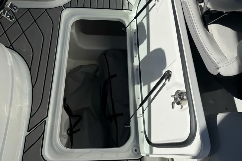 Slide: The Image of Open storage compartment on 2026 Sea Ray SLX 260 boat, featuring sleek interior design. - 30