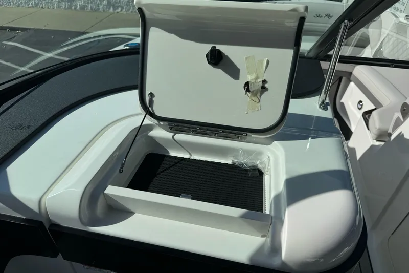 Slide: The Image of 2026 Sea Ray SLX 260 boat storage compartment with open lid, showcasing interior details. - 31