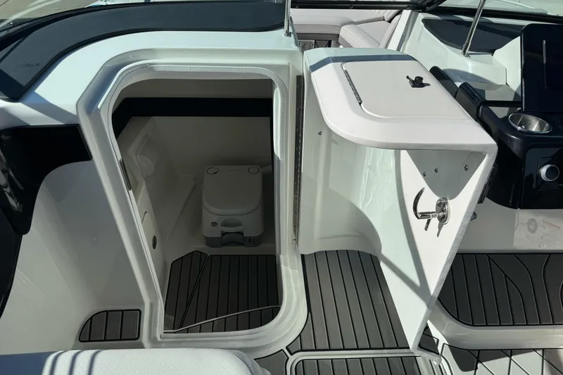 Slide: The Image of 2026 Sea Ray SLX 260 boat interior with compact marine toilet and sleek design. - 32