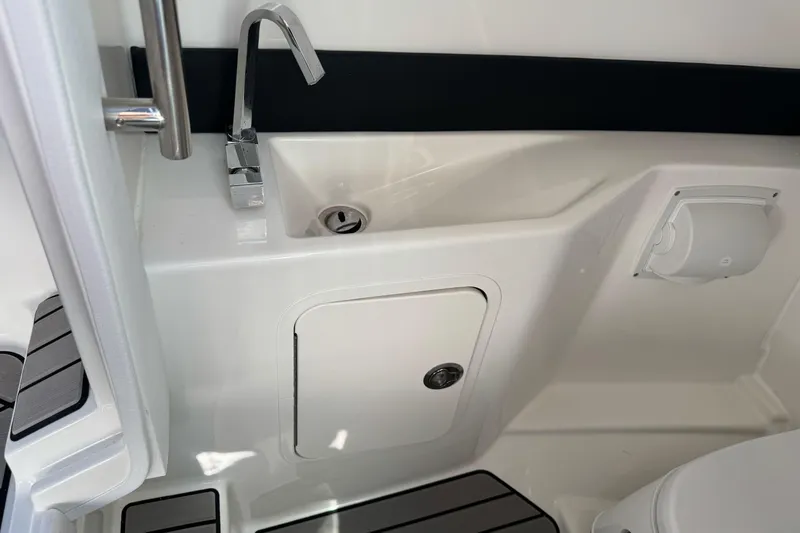Slide: The Image of 2026 Sea Ray SLX 260 boat interior with sink and storage compartment. - 34
