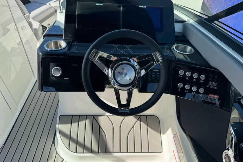 Slide: The Image of 2026 Sea Ray SLX 260 helm with modern steering wheel and control panel. - 35