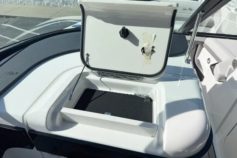 Slide: The Image of Open storage compartment on 2026 Sea Ray SLX 260 boat, showcasing sleek design and functionality. - 26
